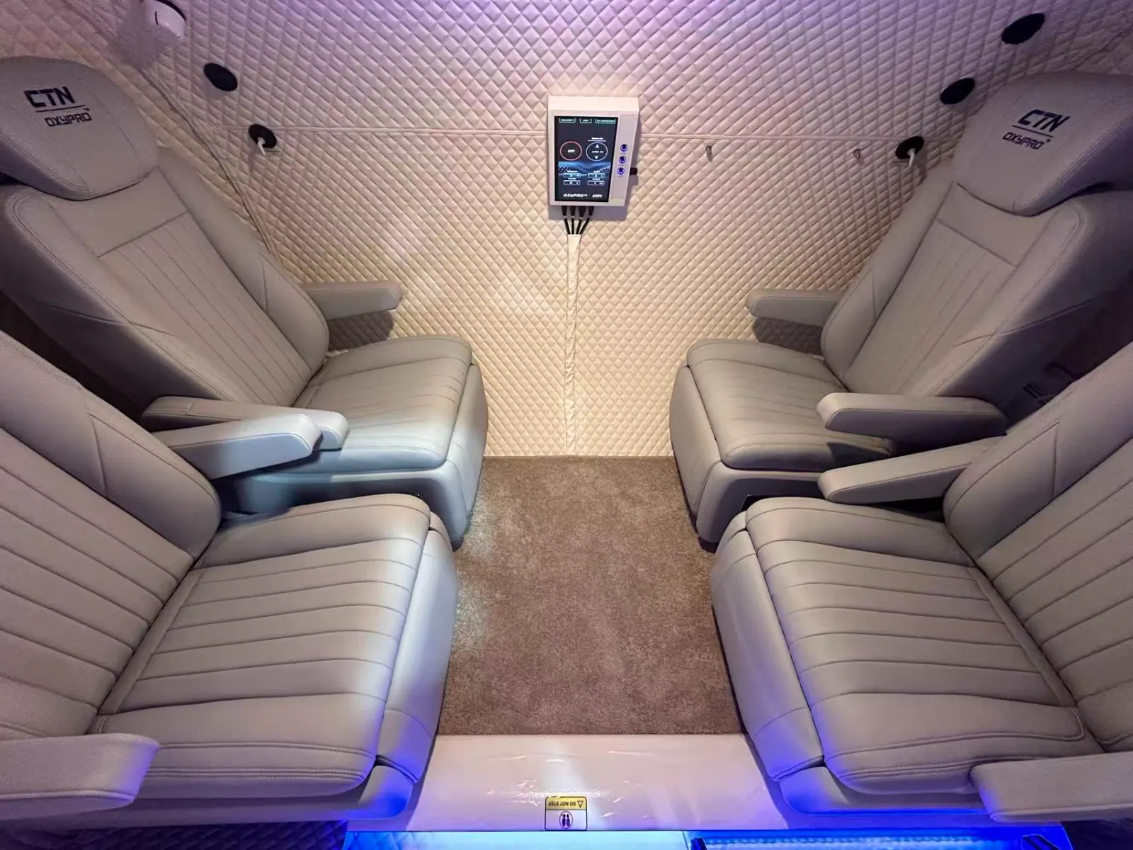 Interior of a multiplace hard shell hyperbaric chamber with seating for several occupants